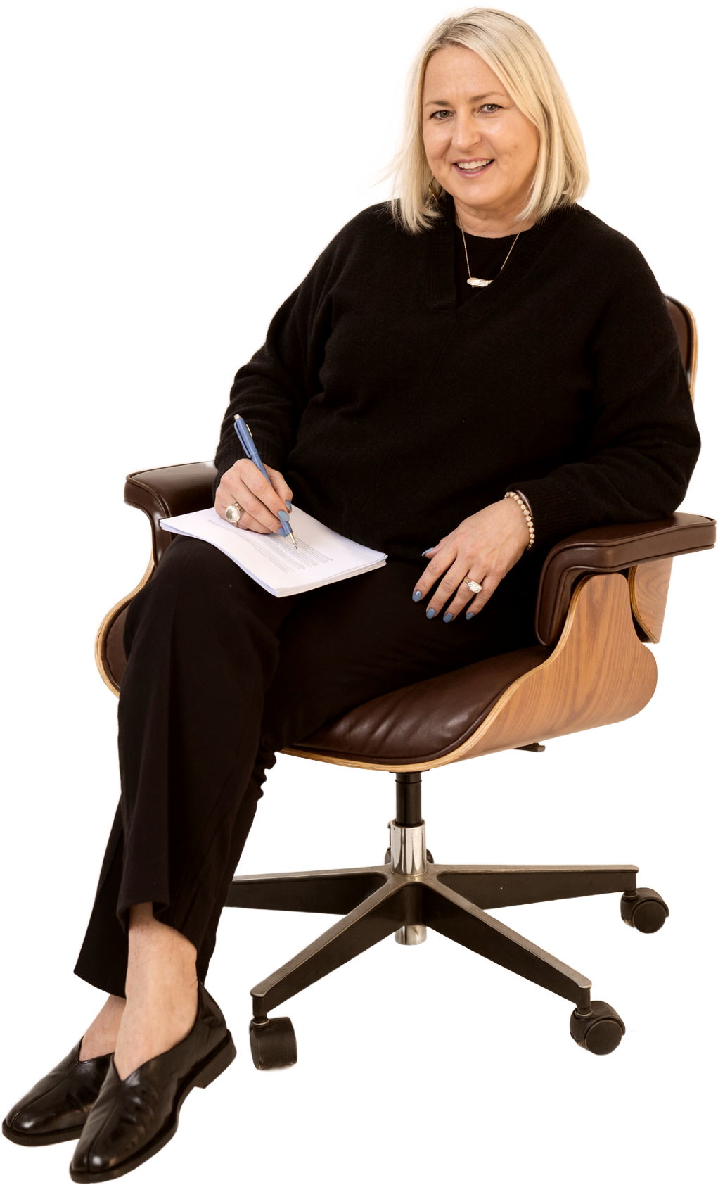 Angela Schellenberg seated, holding a notebook