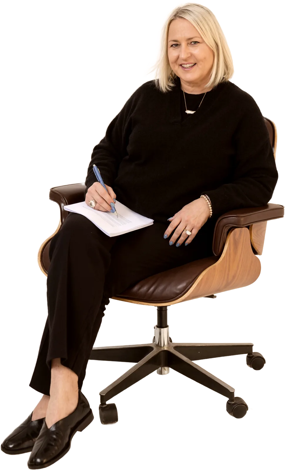 Angela Schellenberg seated, holding a notebook