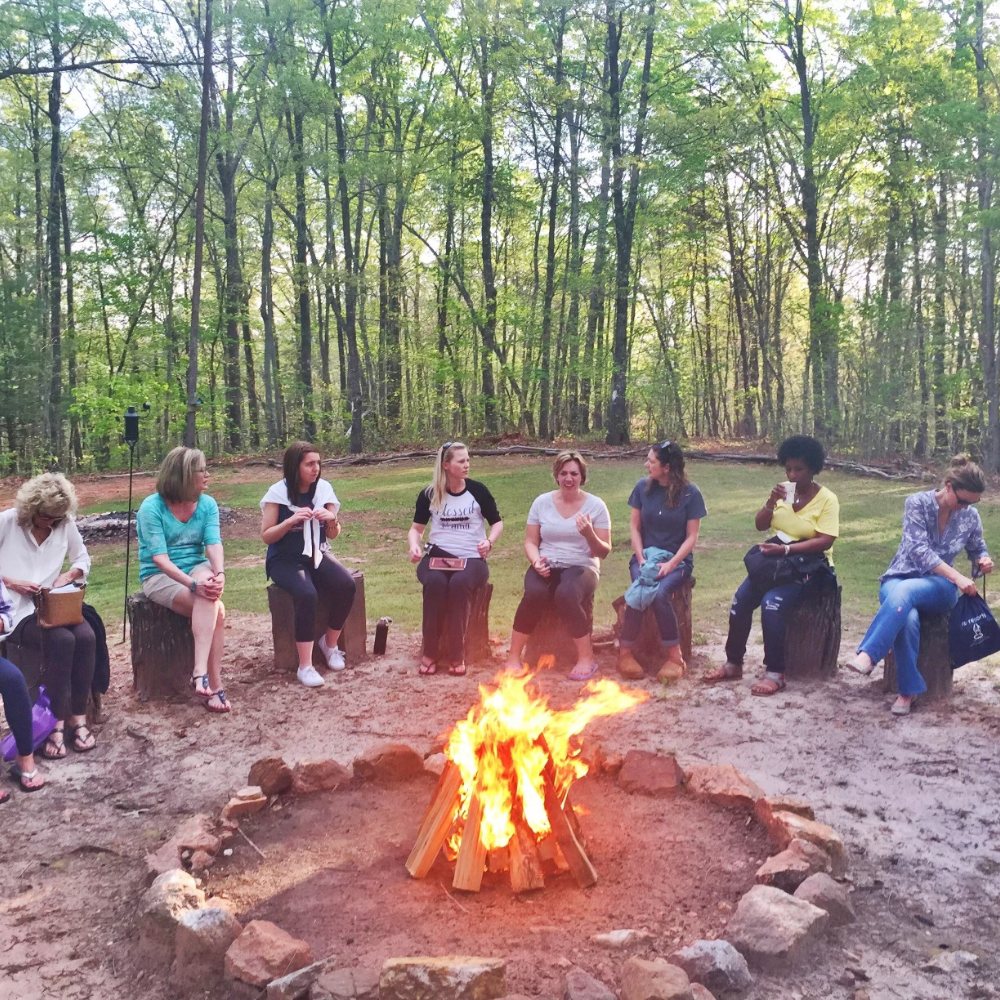 Women gathered around a fire circle