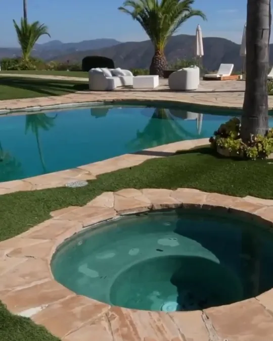 The pool and jacuzzi below the villa