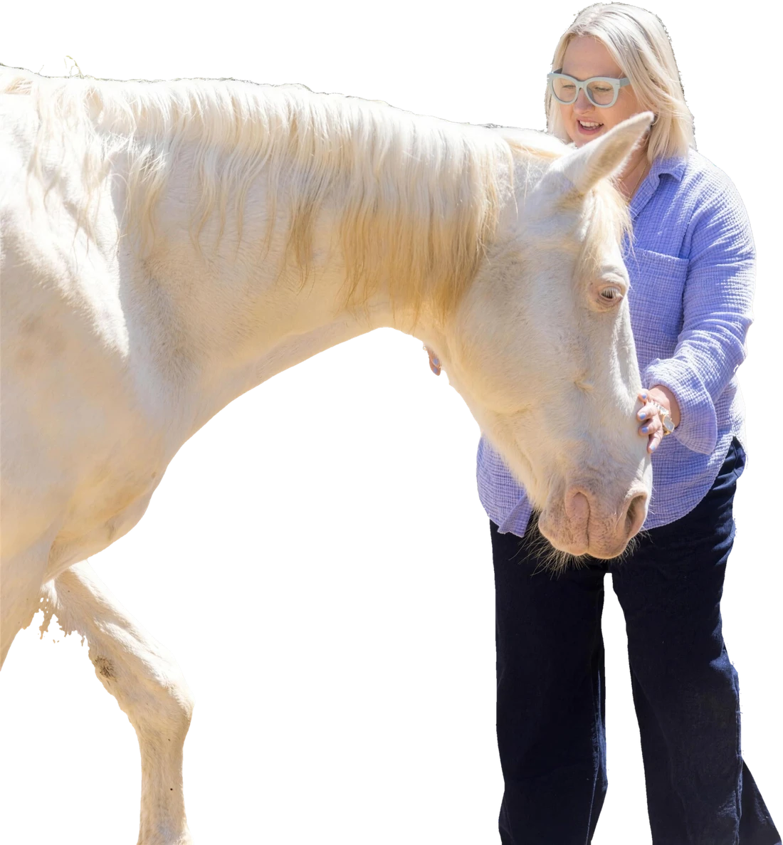 Angela Schellenberg with a white horse at Shakti Ranch