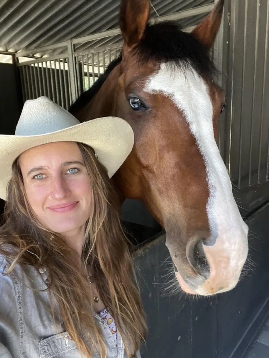 Emma Barnosky with a horse in the stable