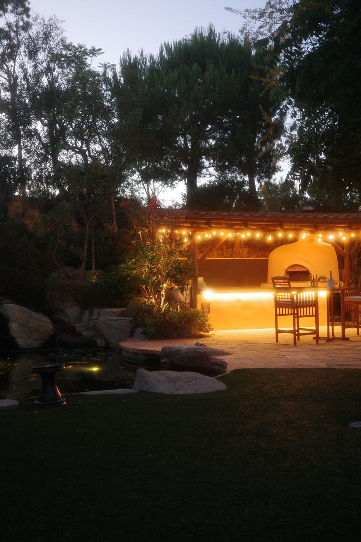 The garden firepit glowing in the evening