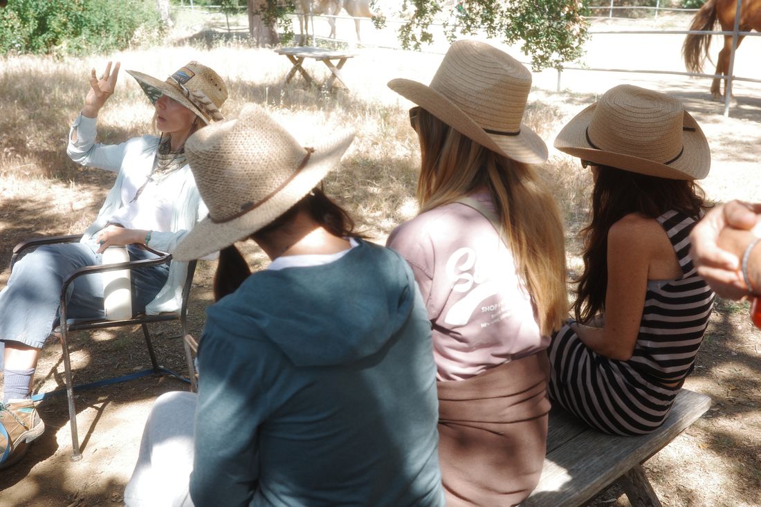 Two guests in sun hats walking together