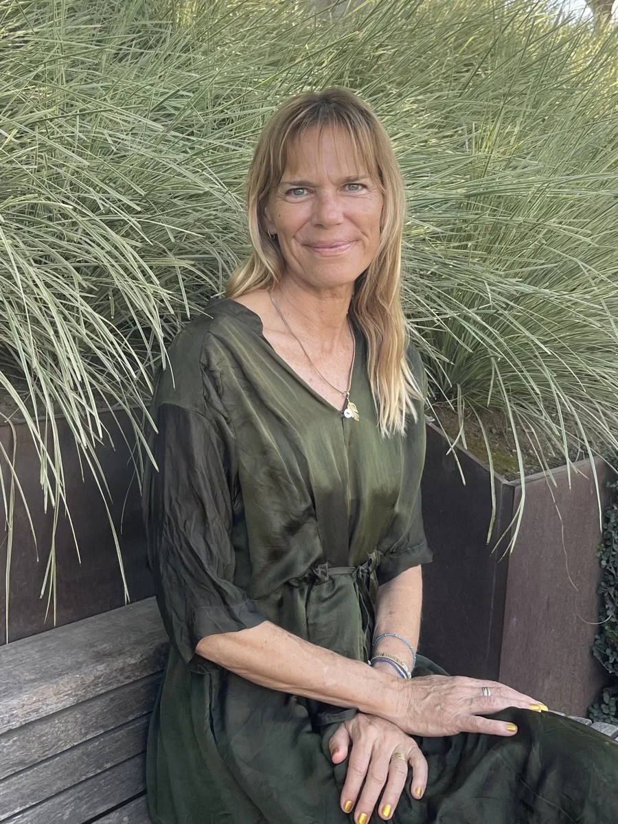 Lara Plutte seated among ornamental grasses