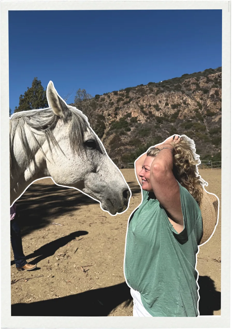 A retreat guest greeting a white horse at Shakti Ranch