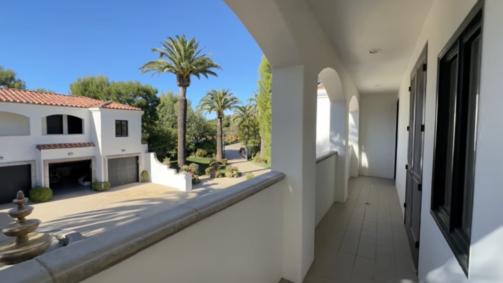 The Blush Room's private balcony, an arched loggia over the palms and gardens