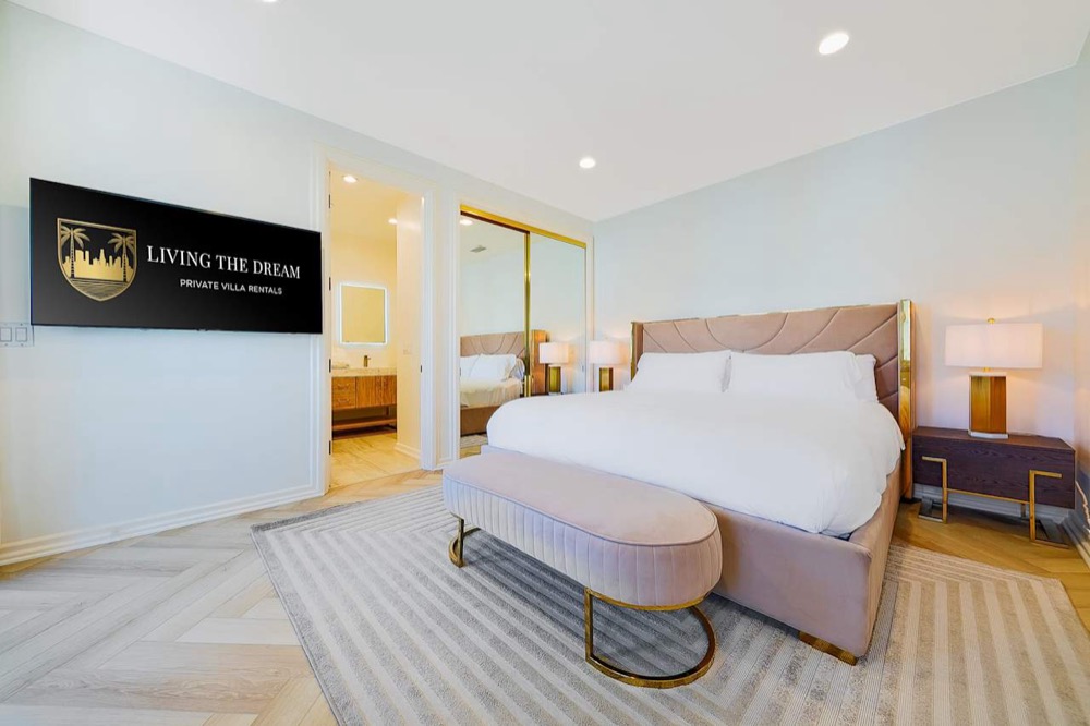 The Blush Room: a shared bedroom with a blush quilted king bed, mirrored gold closets, and soft light