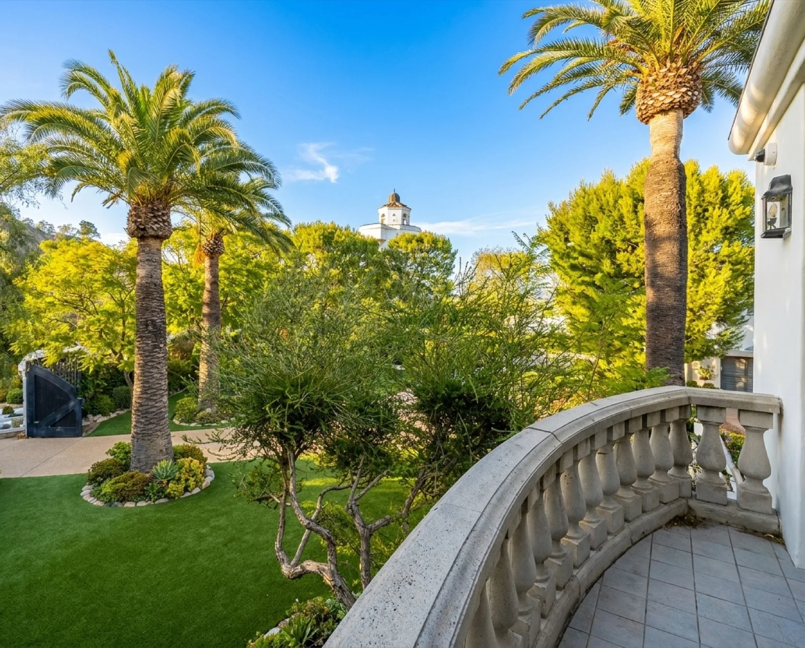 The Cloud Room's curved stone balcony over the gardens, with a view of the estate dome