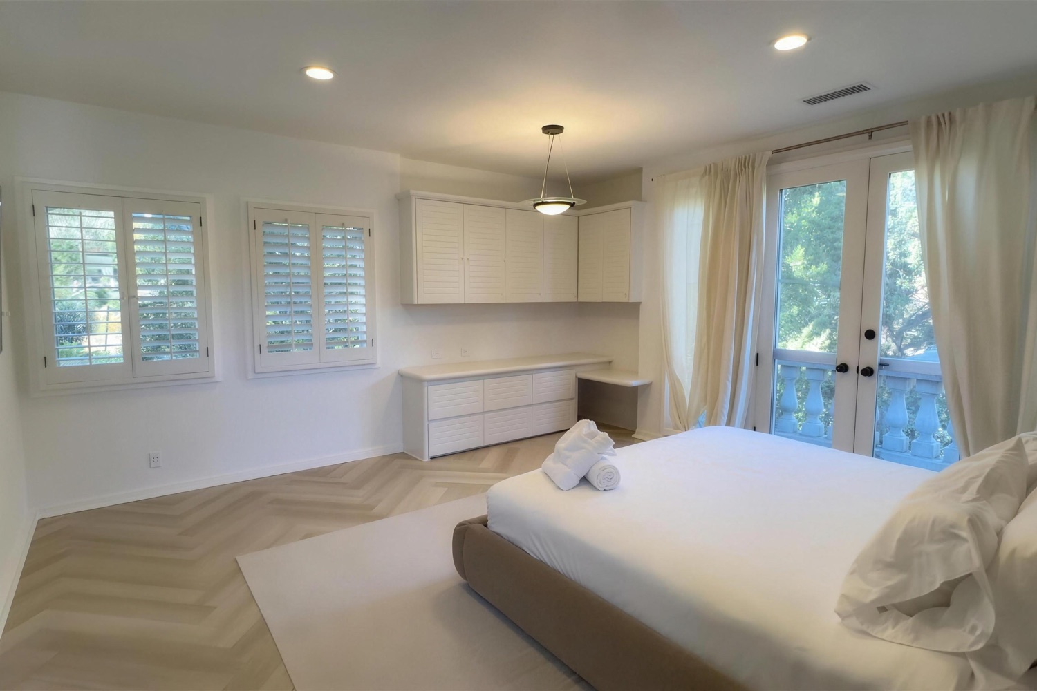 The Cloud Room: a light-filled private bedroom with a king bed and French doors opening to a private balcony