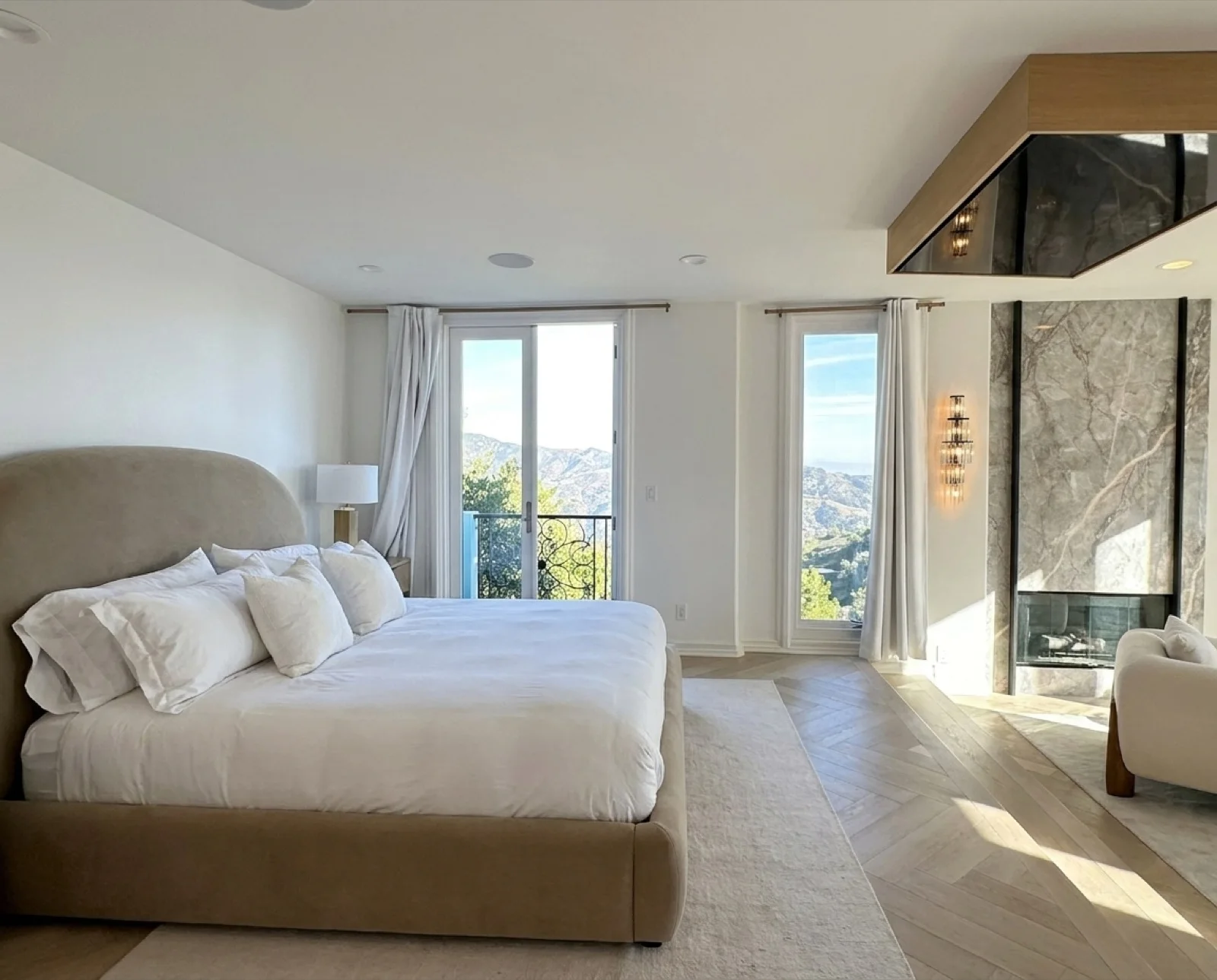 The Master Suite's king bed beneath a crystal chandelier