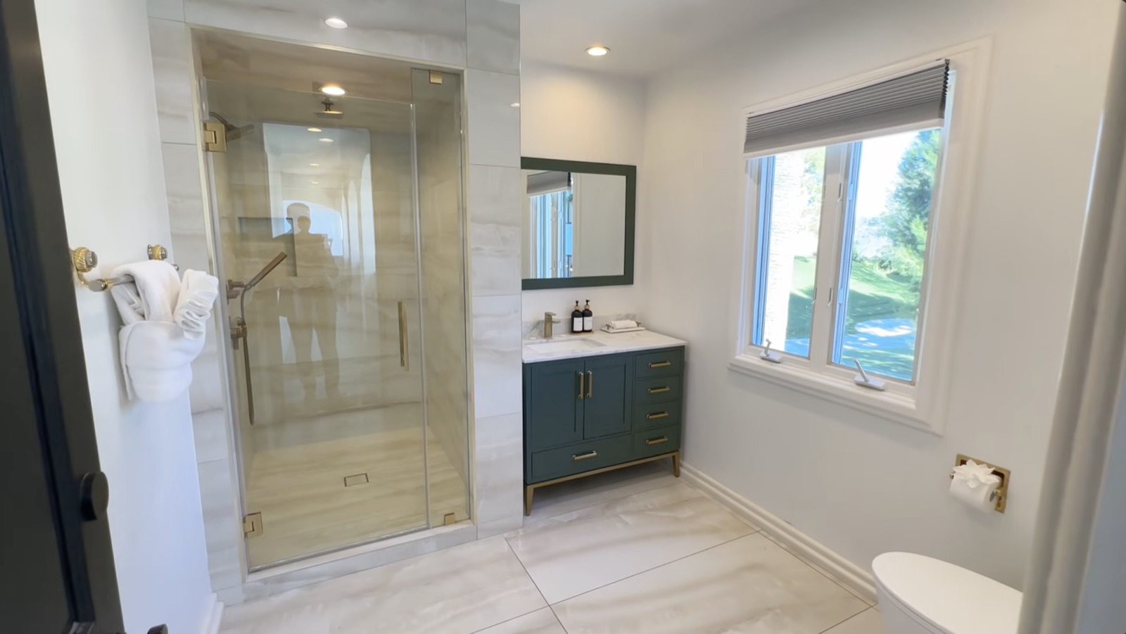 The private in-room bathroom, with a marble walk-in shower and vanity