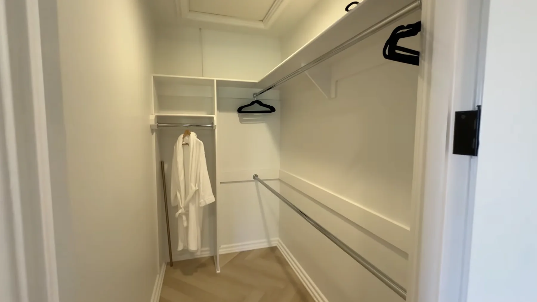 The Terrace Room's walk-in closet, with hanging rails, shelves, and a robe
