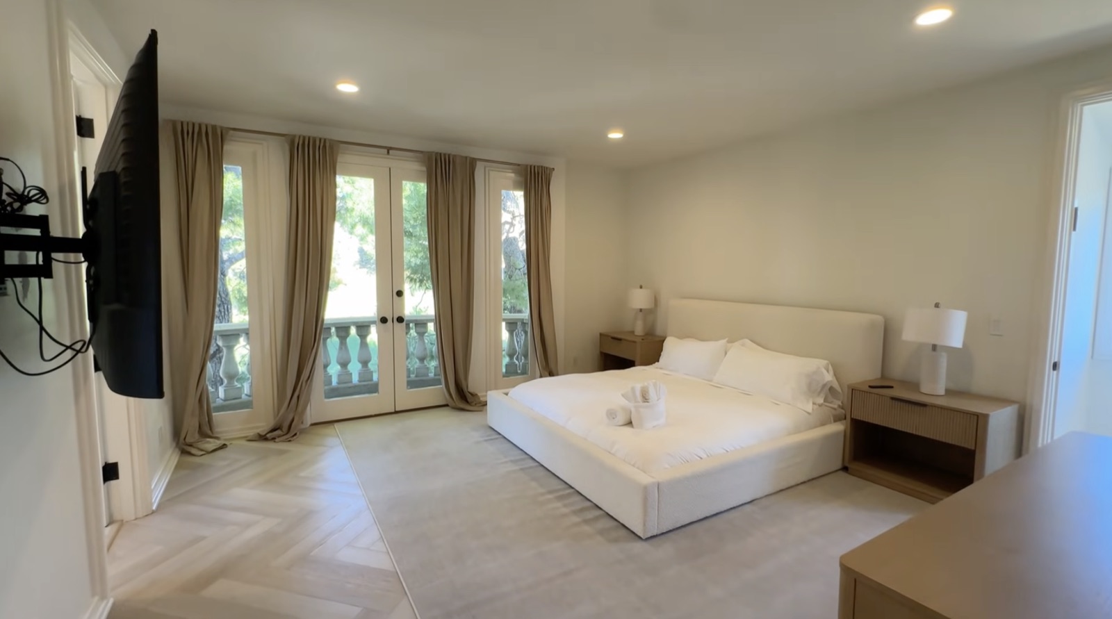 The Terrace Room: a warm, light-filled shared bedroom with a king bed and French doors to a balcony