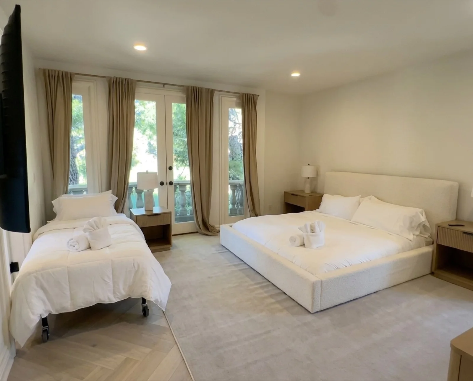 The Terrace Room: a warm, light-filled shared bedroom with a king bed and French doors to a balcony